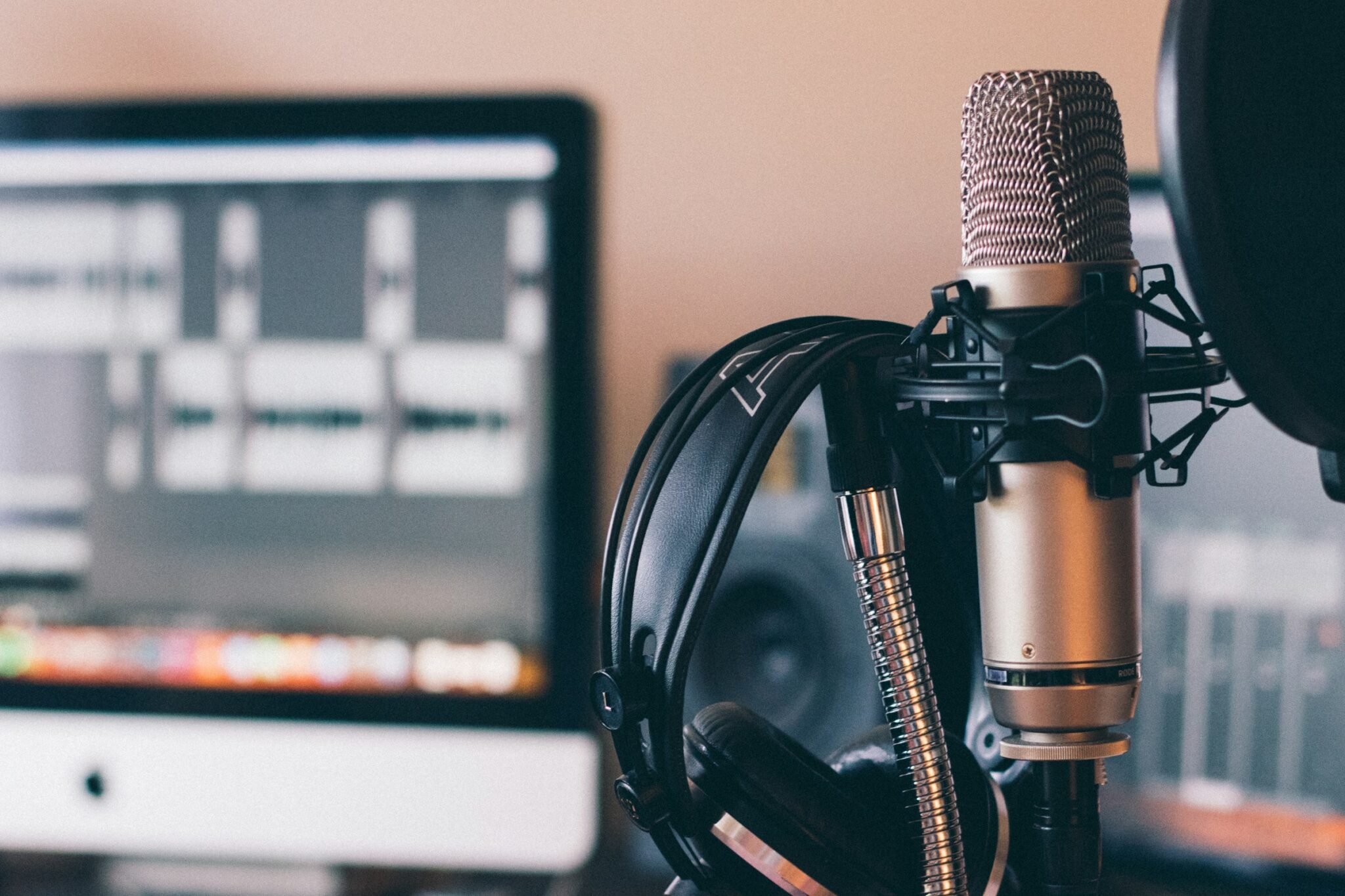 Microphone, headphones and recording software set up for a voice-over session