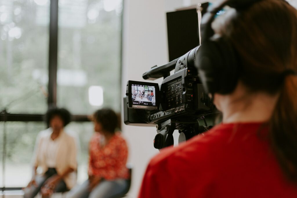 A camera operator filming an interview