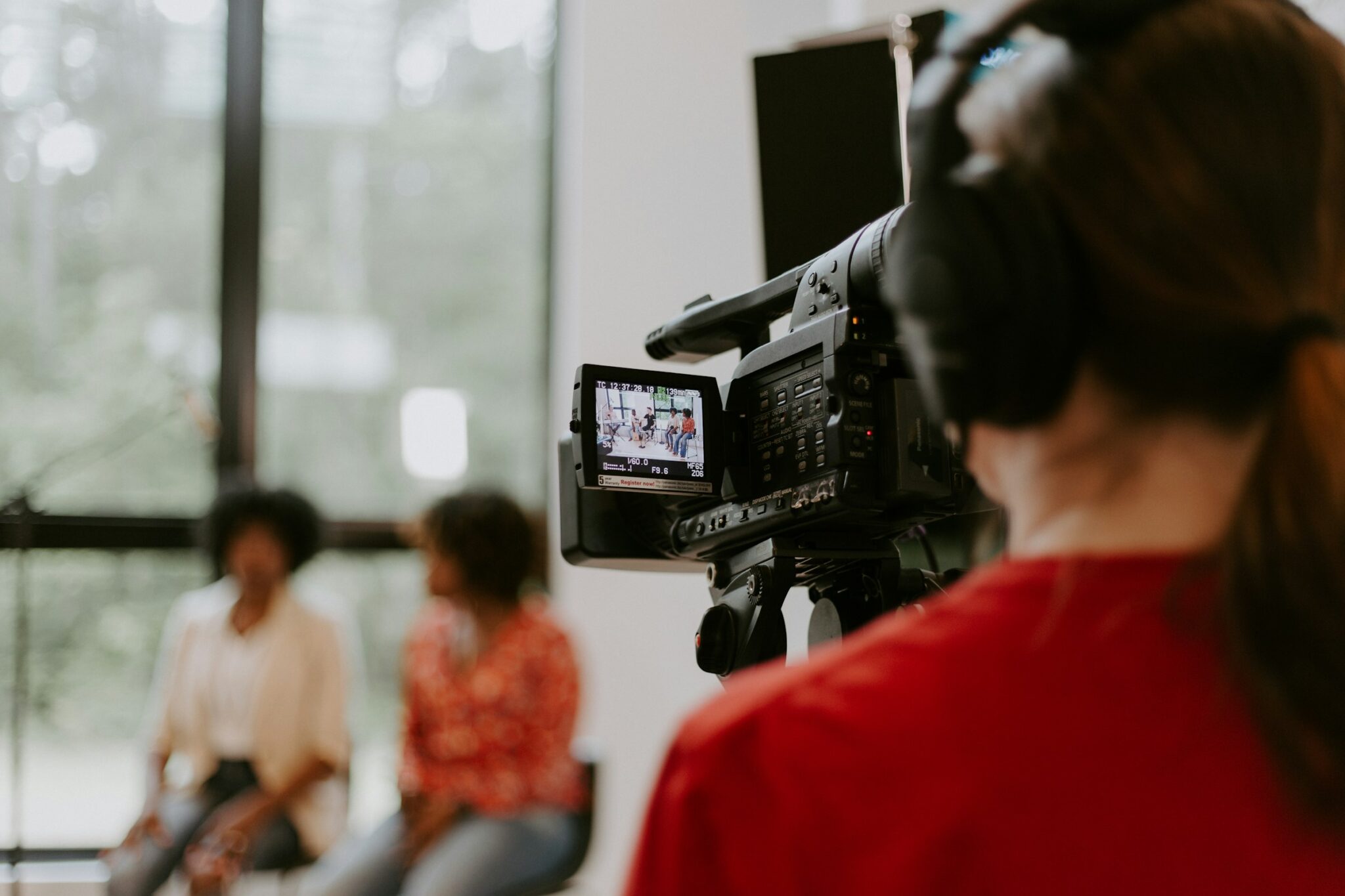 A camera operator filming an interview