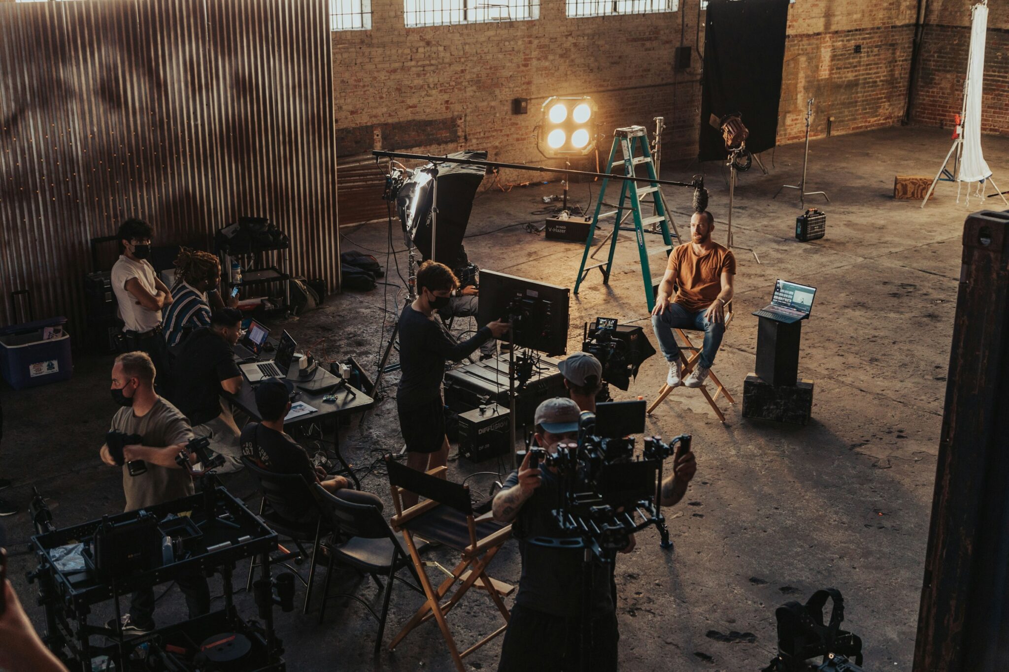 A film crew working around a camera setup on set