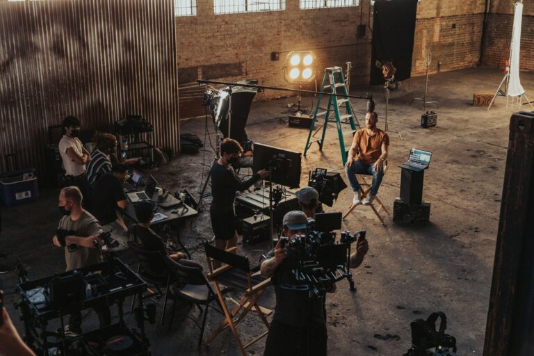 A film crew working around a camera setup on set