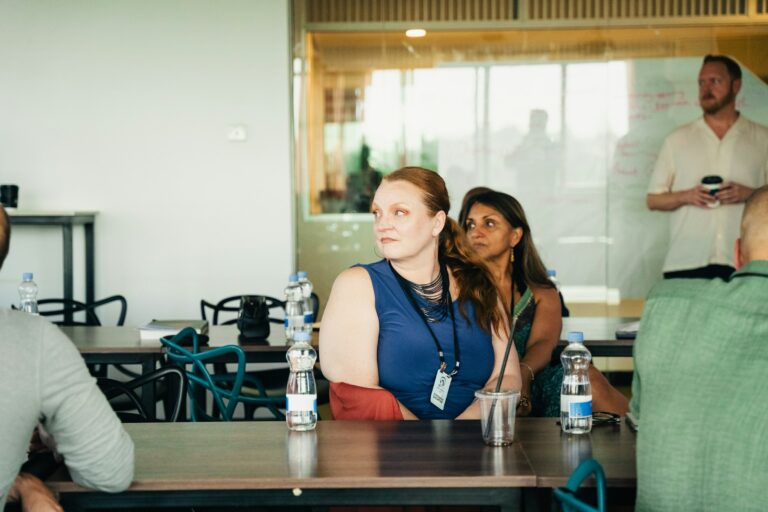 Members of a panel listening to a presentation in a modern office in Nairobi, Kenya